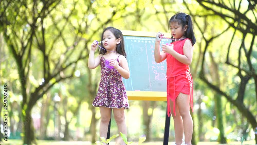 Cute girl play a bubble in playground . learning kids concept . Cute girl play a bubble in playground . learning kids concept .