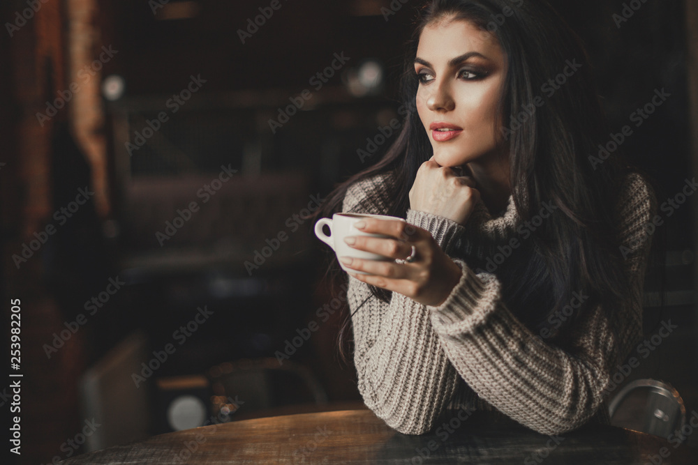 Beautiful woman drinking coffee sitting in a cafe. Beautiful woman drinking coffee sitting in a cafe.