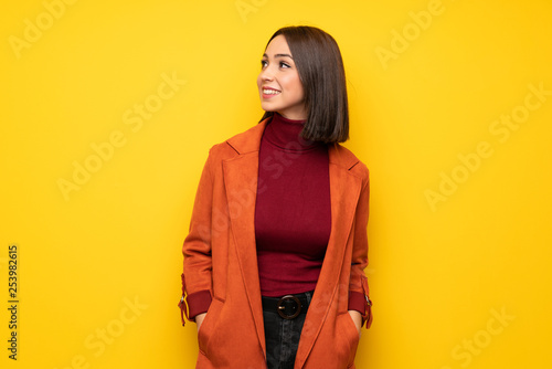 Young woman with coat looking to the side © luismolinero