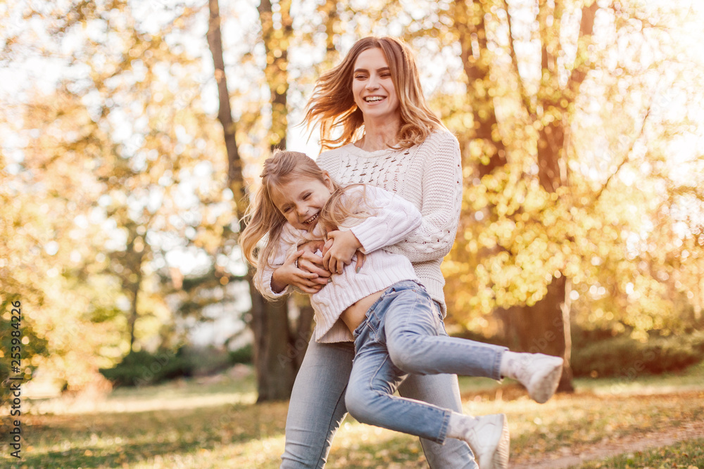 Happy daughter with mother is having fun walking in the park. Happy daughter with mother is having fun walking in the park.