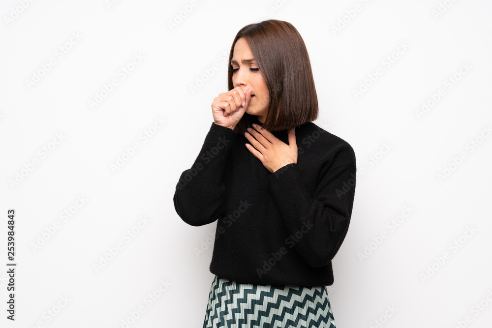 Young woman over white wall is suffering with cough and feeling bad Young woman over white wall is suffering with cough and feeling bad
