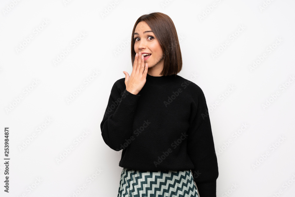 Young woman over white wall with shocked facial expression Young woman over white wall with shocked facial expression