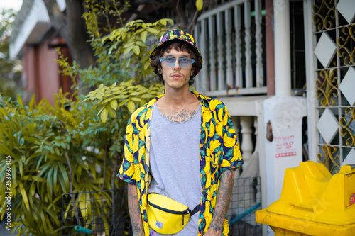 Принти на полотні Portrait of young rebellious man with plants outdoors
