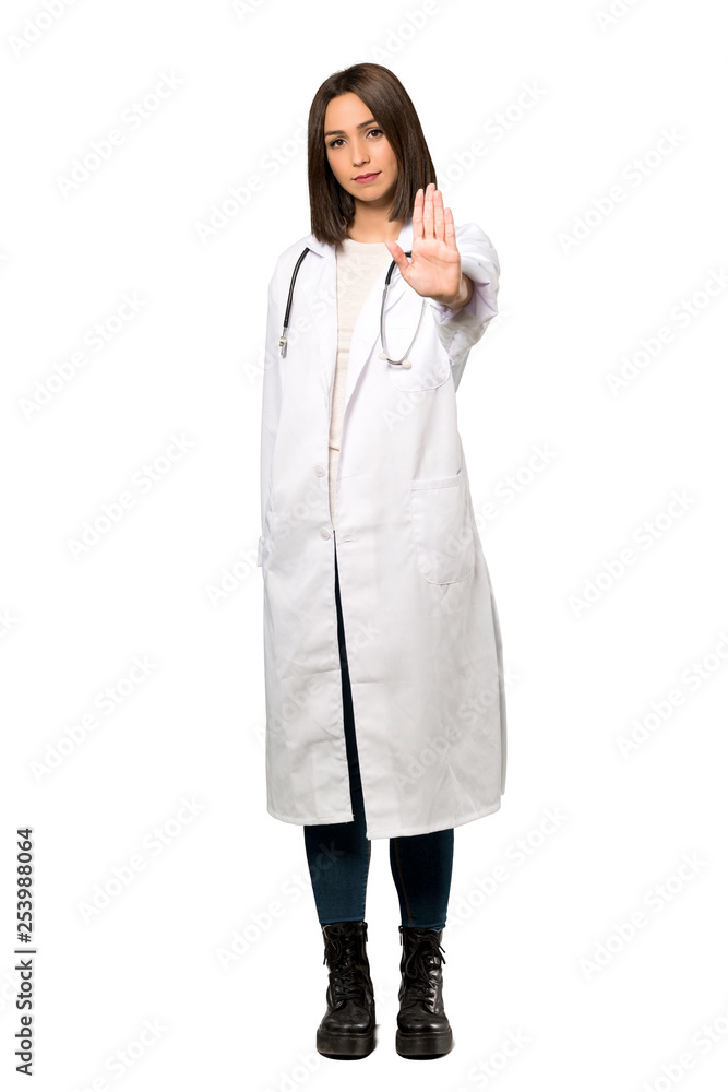 A full-length shot of a Young doctor woman making stop gesture denying a situation that thinks wrong over isolated white background