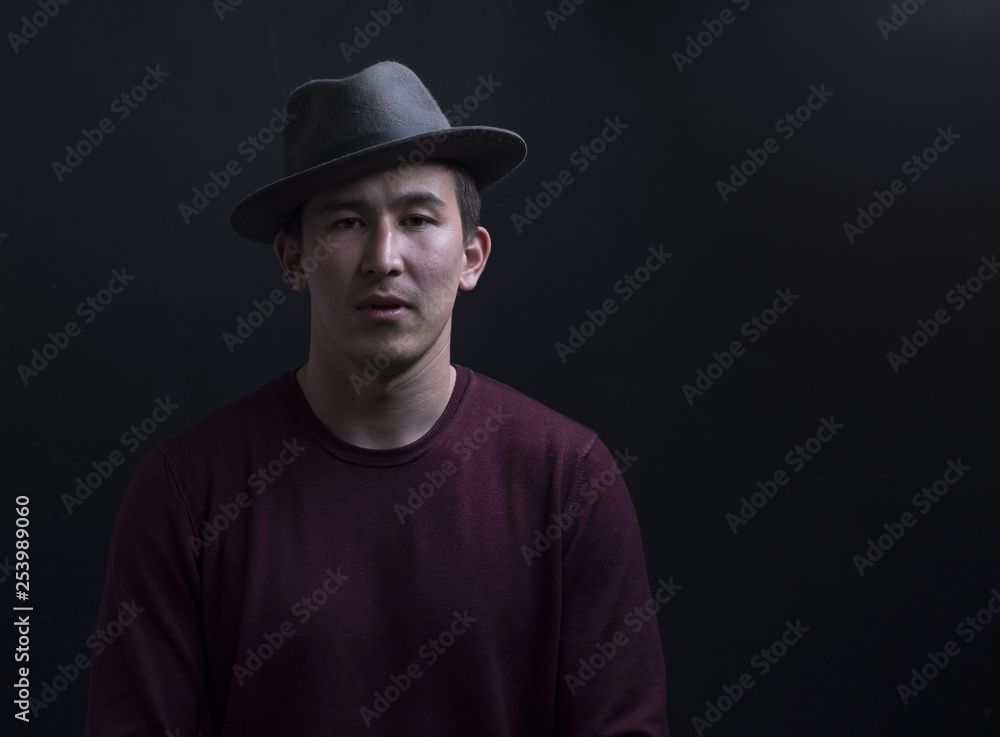 studio portrait of a handsome young man in a hat on a black background studio portrait of a handsome young man in a hat on a black background