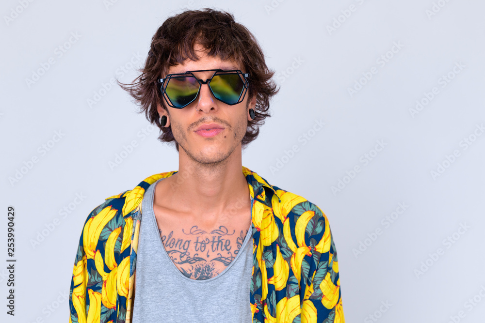 Face of young rebellious man wearing sunglasses looking cool Face of young rebellious man wearing sunglasses looking cool