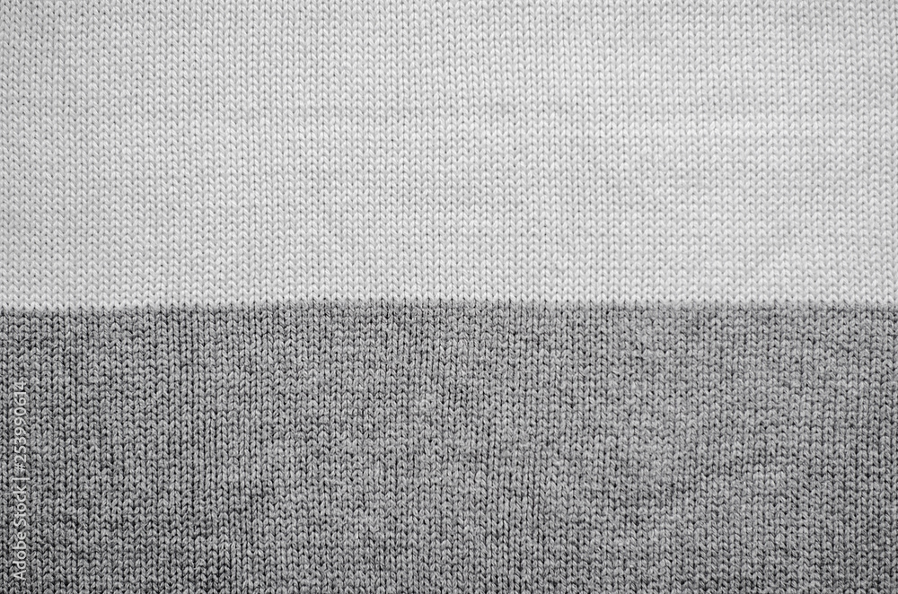 Fototapeta premium White knitted fabric background. The texture of the white wool fabric. 