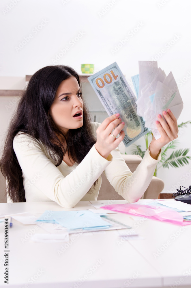 Young woman with receipts in budget planning concept Young woman with receipts in budget planning concept