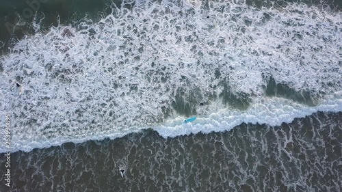 A drone shot of surfers on the beach of Taghazoute in Morocco photo