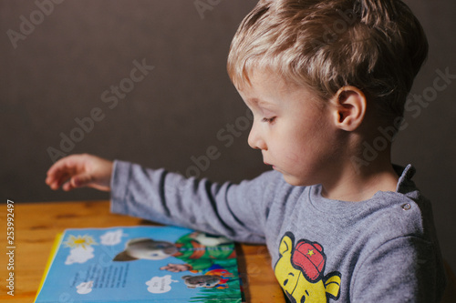 little child learns to read a book