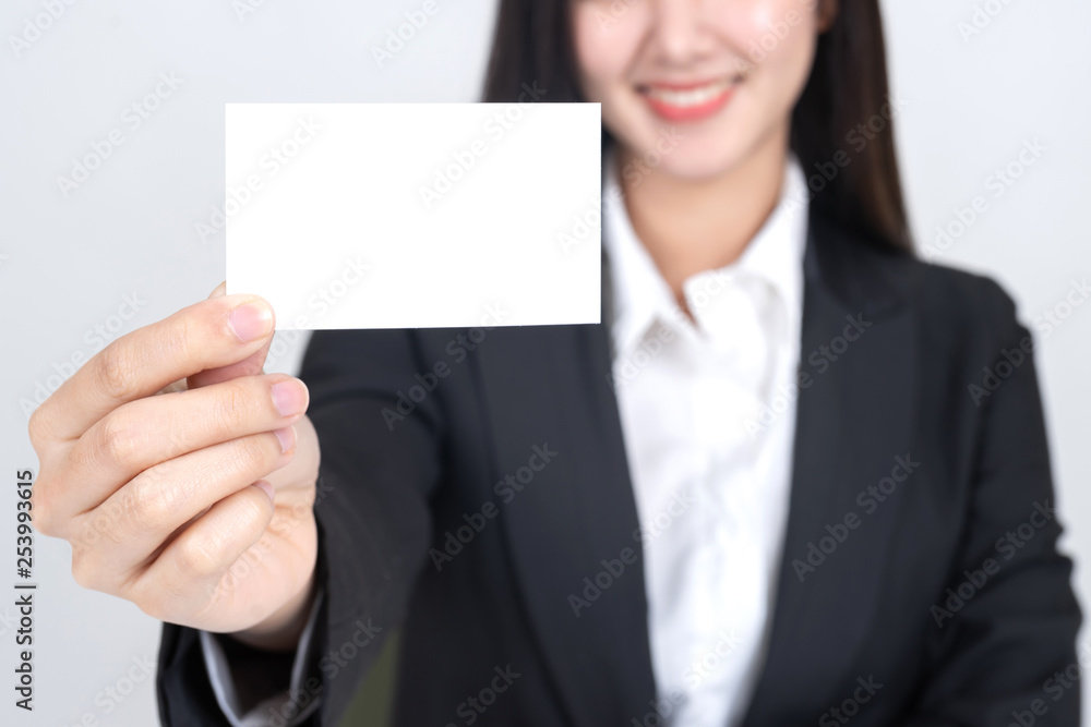 business woman holding and showing empty business card or name card - business concept business woman holding and showing empty business card or name card - business concept