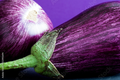 Ripe purple eggplants macro view pattern texture. Beautiful organic food colorful background.