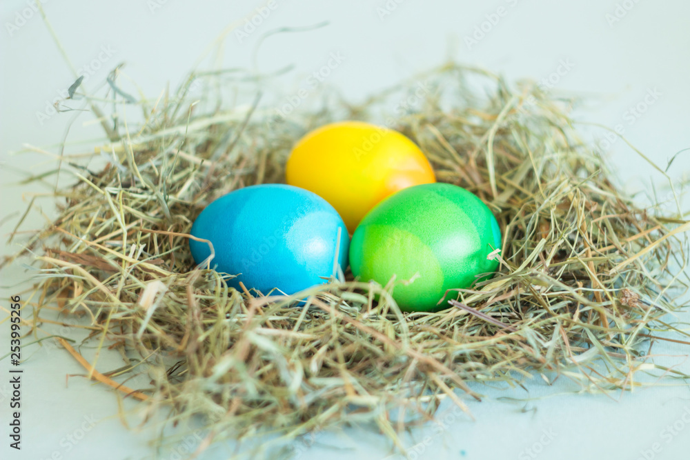 ombre colors painted Easter eggs lie in the nest, the background is neutral ombre colors painted Easter eggs lie in the nest, the background is neutral