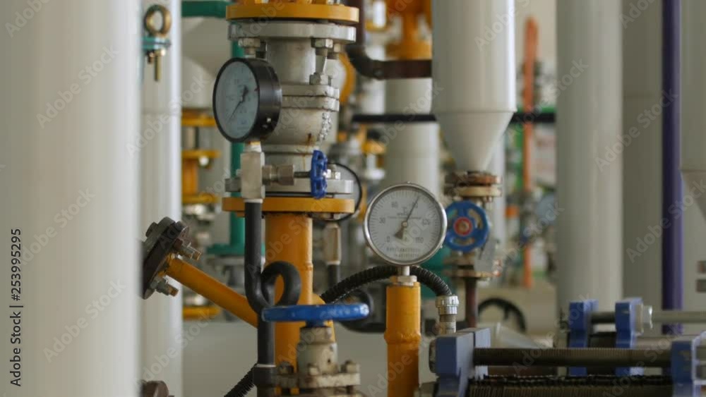 Pipes & valves inside a mechanical room of a industrial manufacturing plant Pipes & valves inside a mechanical room of a industrial manufacturing plant