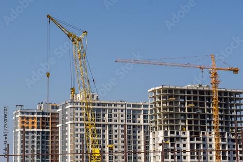 Construction crane and high-rise building under construction