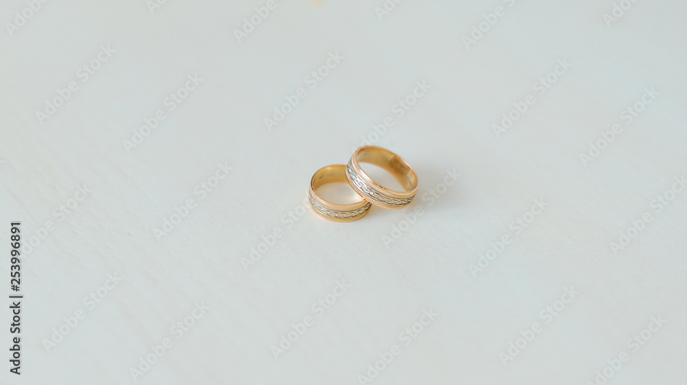 wedding rings on a wooden background. Rings of the bride and groom on a wooden cut. Wedding Concept wedding rings on a wooden background. Rings of the bride and groom on a wooden cut. Wedding Concept