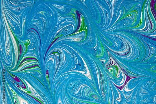 Beautiful abstract drawing technique Ebru in blue .Turkish style of painting Ebru on water with acrylic paints swirls waves.A stylish combination of natural luxury