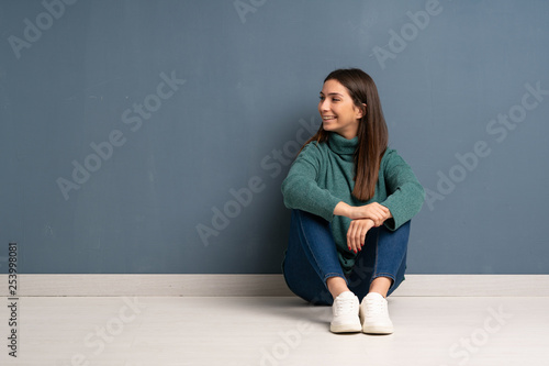 Young woman sitting on the floor Happy and smiling