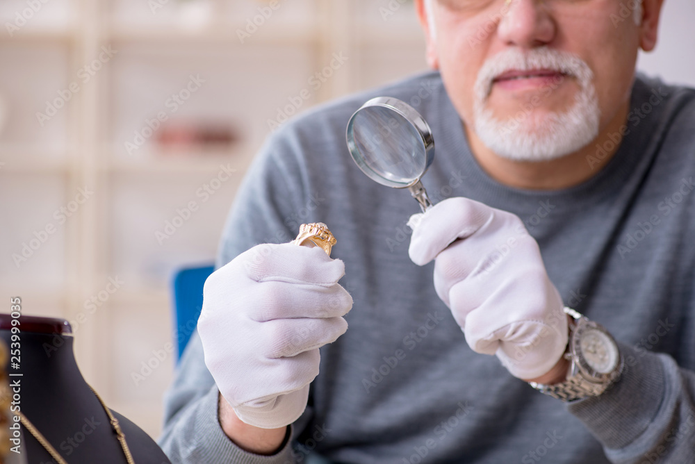 White bearded old jeweler at workshop White bearded old jeweler at workshop