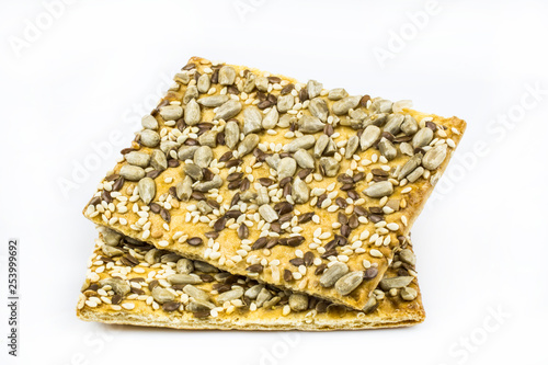 Two cookies with the content of cereals isolated on a white background.