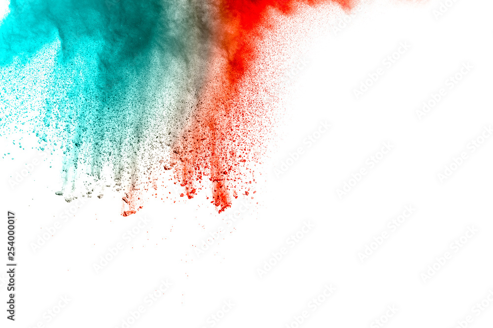 Abstract multi color powder explosion on white background.  Freeze motion of  dust  particles splashing. Painted Holi.