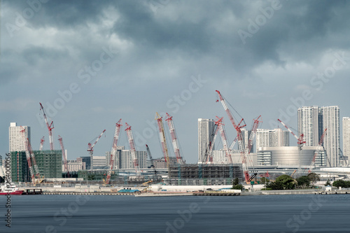 crane and buildings in a construction site in Tokyo city bay area.