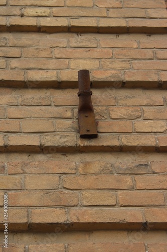  Old flagpole on the wall of an old brick building