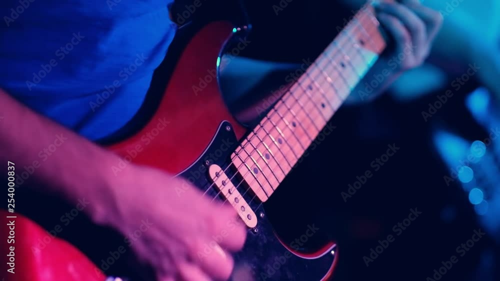 guitar player playing ona the guiter on the stage, close up