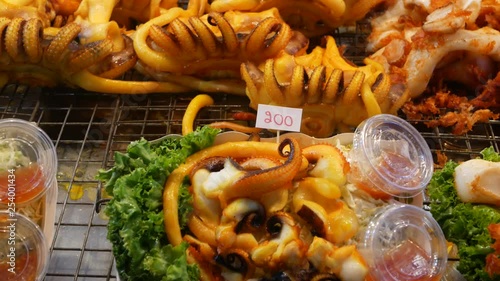 National Asian Exotic ready to eat seafood at night street market food court in Thailand. Delicious Grilled Prawns or Shrimps and other snacks photo