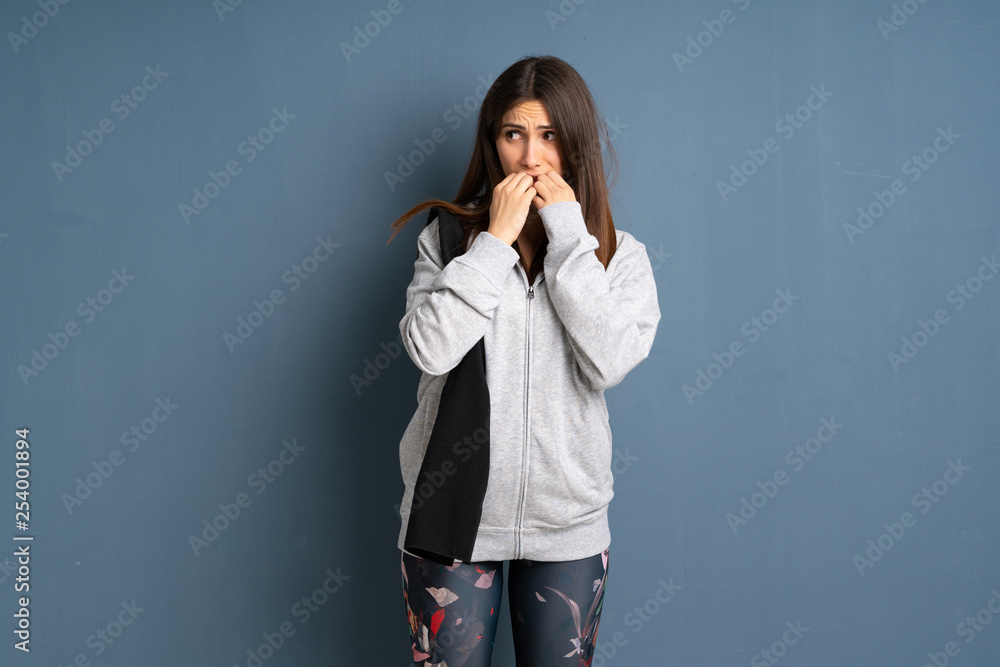 Young sport woman nervous and scared putting hands to mouth Young sport woman nervous and scared putting hands to mouth