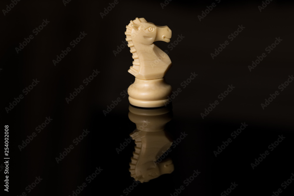 Classic Chess White Horse on black board, isolated Classic Chess White Horse on black board, isolated