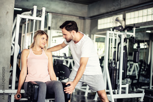 Portrait Fitness coaches are controlling the training equipment of lovers, Helps create motivation for exercise,fitness concept 