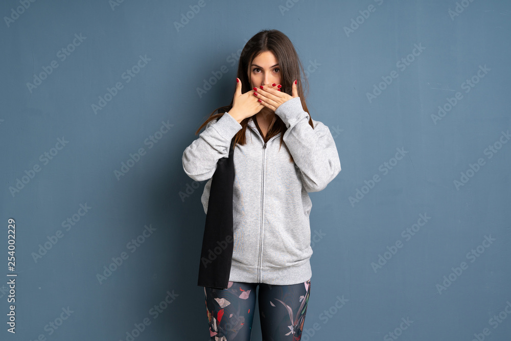 Young sport woman covering mouth with hands for saying something inappropriate Young sport woman covering mouth with hands for saying something inappropriate