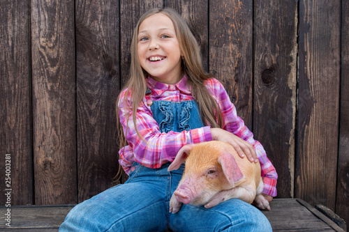Farmer's children are playing with pig