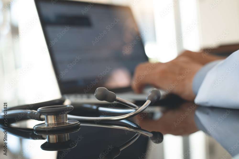 Doctor working on laptop computer Doctor working on laptop computer