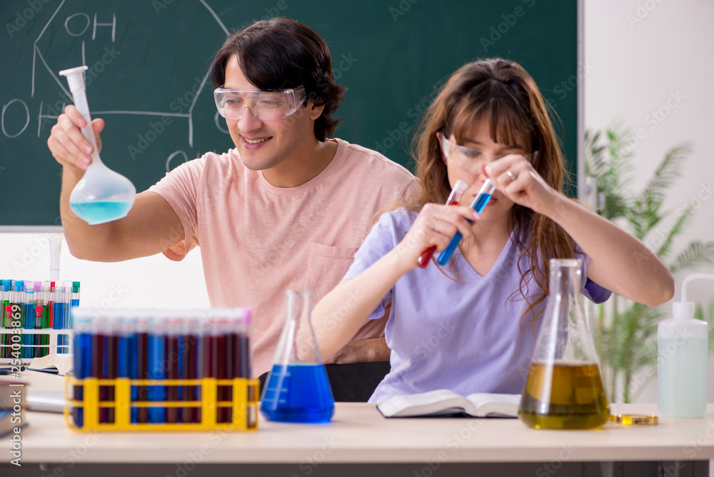 Two chemists students in classroom Two chemists students in classroom