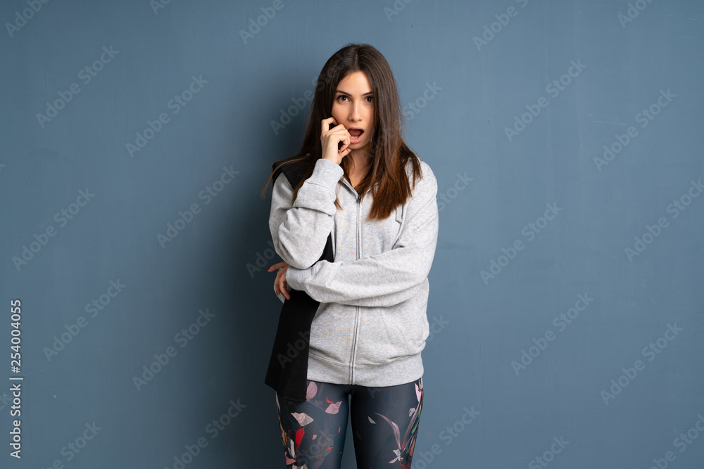 Young sport woman surprised and shocked while looking right Young sport woman surprised and shocked while looking right