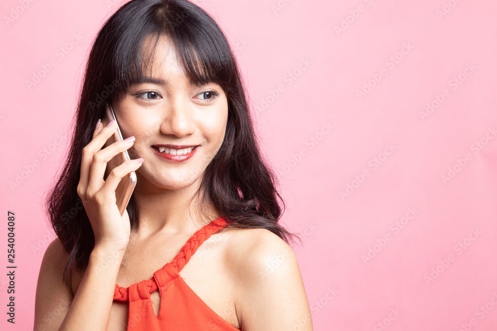 Young Asian woman talking with mobile phone. Young Asian woman talking with mobile phone.
