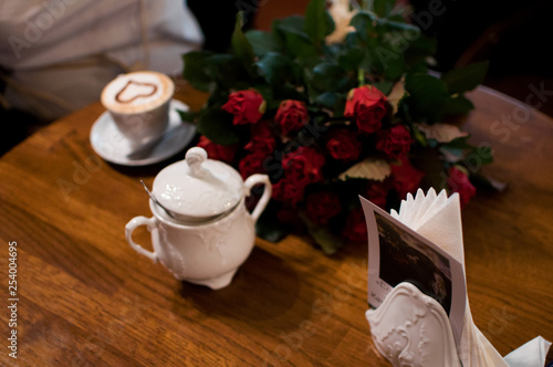 cup of coffee and flowers on table