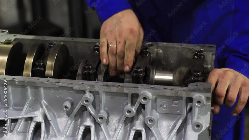 A man repairs car engine