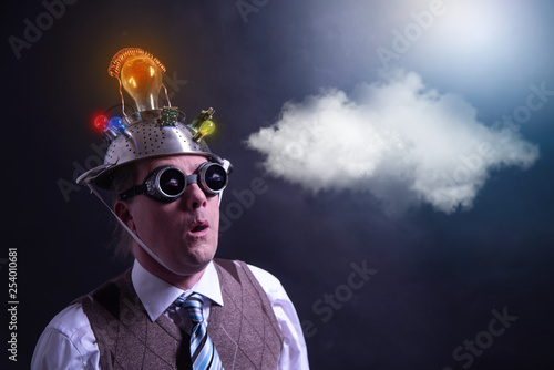 distraught looking conspiracy believer in suit with aluminum foil head with chemtrails cloud chemtrail