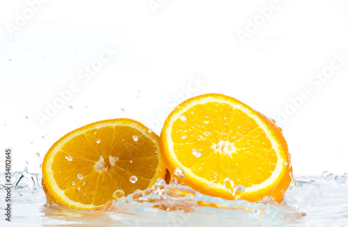 Fototapeta Naklejka Na Ścianę i Meble -  Orange and grapefruit in a spray of water on a white background