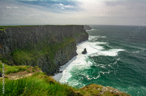 Cliffs of Moher, The Burren, Ireland with crashing waves photo