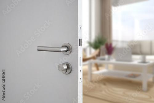 Door handle , door open in front of blur interior room background, selective focus photo