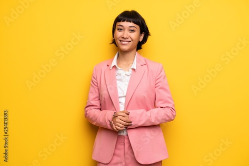 Modern woman with pink business suit posing and laughing looking to the front