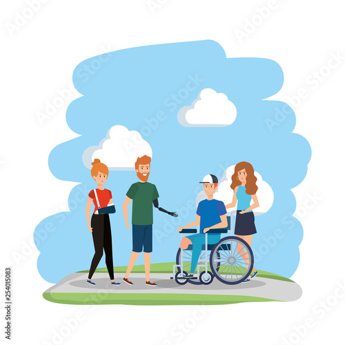 young man in wheelchair with friends in the park