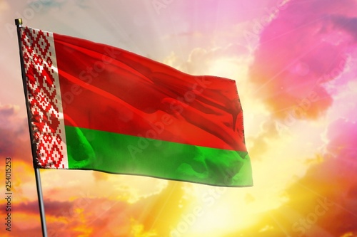 Fluttering Belarus flag on beautiful colorful sunset or sunrise background. Success concept.