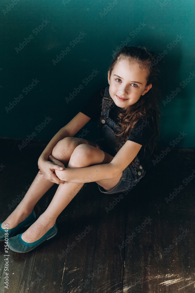 Fototapeta premium Teen pretty cute caucasian girl posing at home on green wall background. Beauty, childhood, emotions concept