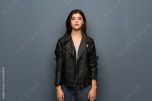 Teenager girl over grey wall portrait