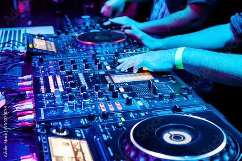 Dj mixes the track in nightclub at party. Body part on the DJ's music control panel